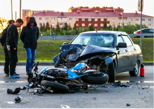 Car motorcycle with bystanders Totaled car and motorcycle after accident.